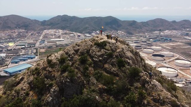 Group of friends do Via Ferrata climb mountain with safety equipment in Cartagena, Region of Murcia, Spain