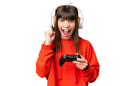 Little caucasian girl playing with a video game controller over isolated background celebrating a victory in winner position