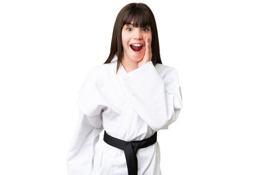 Little Caucasian girl doing karate over isolated background with surprise and shocked facial expression