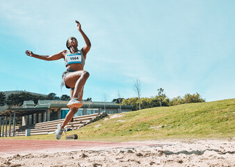 Athletics, fitness and sports woman doing long jump in outdoor competition, athlete challenge or...