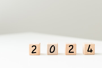 Wooden 2023 to 2024 new year white background. Word 2023 - 2024 wood cube on wooden desk for copy space. 