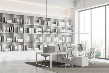 White office room interior with pc monitors in row, shelf with panoramic window