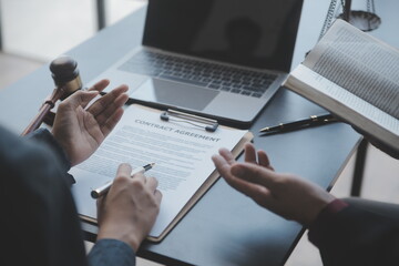 Business and lawyers discussing contract papers with brass scale on desk in office. Law, legal...