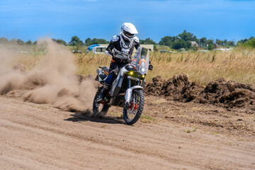 Motocross rider riding on extreme dust track