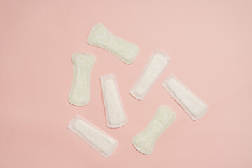 Different feminine sanitary napkins (sanitary pads) on pink background. Menstruation