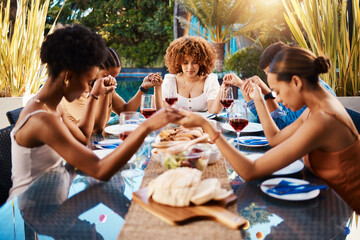 People, food and holding hands to pray outdoor at table for gratitude and holiday celebration. Group of people together at lunch, party or reunion with drinks in garden for thanks, prayer and grace