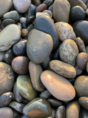sea ​​stones pebbles lighting before sunset top view
