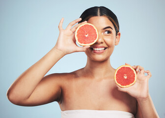 Smile, skincare and woman in studio with grapefruit for natural skin beauty or wellness on grey background. Happy, fruit and female model with citrus cosmetics for vitamin c, collagen and exfoliate