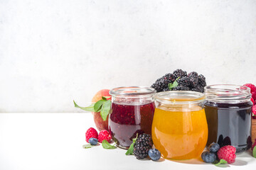 Assortment of berries and fruits jams in jars
