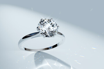 Diamond ring in a spotlight on white background. White gold solitaire engagement ring with a big round stone.