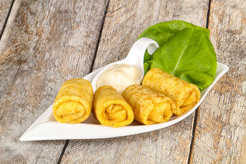 Stuffed pancakes with cream sauce