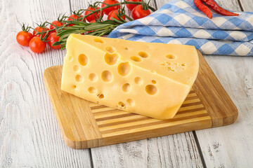 Maasdam cheese piece over board
