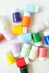 Banks of gouache, multi-colored acrylic paints isolated on white background.