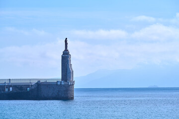 Statue Of El Santo In The Port Of Tarifa - obrazy, fototapety, plakaty