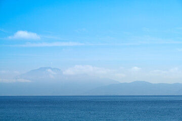 Obraz premium Mediterranean sea, blue sky and clouds with mountains in Africa