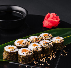 Sushi Rolls Set with Salmon on black plate
