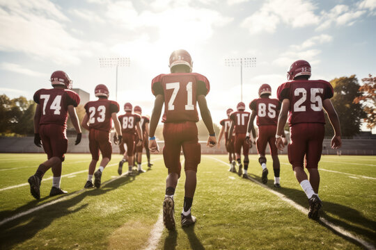 Teenage boy high school football team running onto the field before a game, pumped up and ready to play