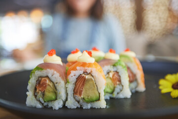 Closeup, restaurant plate and sushi for lunch, eating seafood and Chinese food on bokeh. Zoom, health and a hungry person with a luxury fine dining dish of fish, Asian cuisine and dinner at a cafe