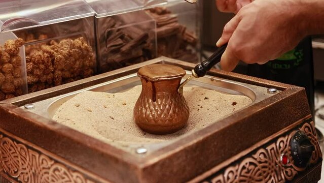 Making coffee on the hot sand in a traditional way