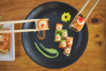 Sushi, seafood and chopsticks in a chinese restaurant from above for dining or traditional cuisine....