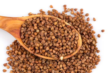 Fototapeta premium Uncooked buckwheat on wooden spoon