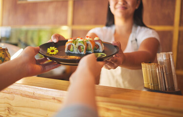 Sushi, restaurant worker and woman hands with smile from food and Asian meal in kitchen. Happy,...