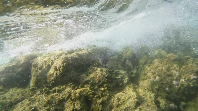 Waves hitting a rock underwater