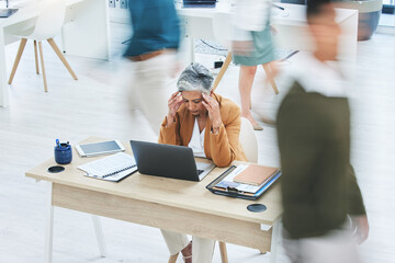 Busy office, stress and senior woman with headache, crisis or vertigo while working on a laptop....