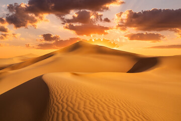 Fototapeta na wymiar Sunset over the sand dunes in the desert. Arid landscape of the desert.