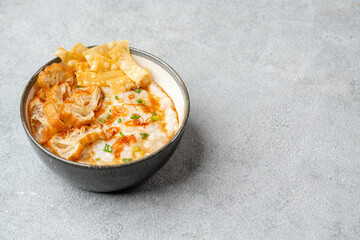 Rice porridge or congee with cakwe in bowl