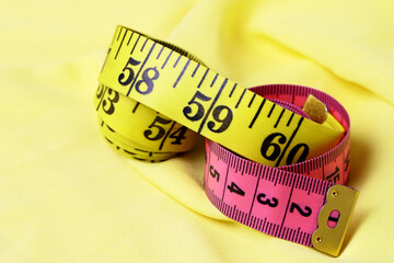 yellow and red measuring tape on a yellow fabric background