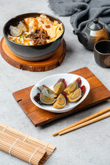 Rice porridge or congee with minced pork, century egg and cakwe in bowl