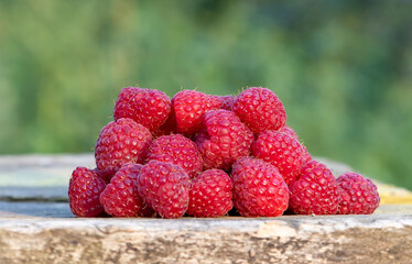 Red raspberry on the board. Blurred background.