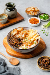 Rice porridge or congee with minced pork, century egg and cakwe in bowl