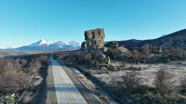 Mylodon Sculpture At Puerto Natales In Ultima Esperanza Chile. Snowy Mountains. Road Landscape. Ultima Esperanza Chile. Mylodon Sculpture At Puerto Natales In Ultima Esperanza Chile.