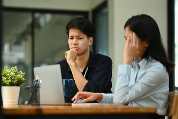Stressed male and female employee frustrated by business problem or dissatisfied with work results.