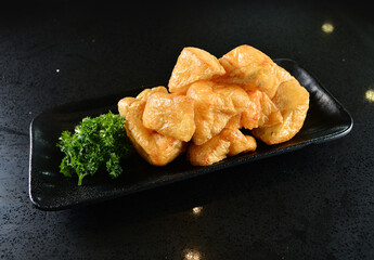 cold mixed raw vegetables,  beancurd, mushroom, carrot, noodle, tofu, lotus, corn in plate for steam boat hot pot ingredient on black marble table asian halal food cuisine menu for restaurant