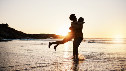 Beach sunset, silhouette and couple hug, celebrate and enjoy romantic time together, bonding and...