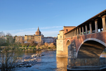 Obraz premium Pavia, Italy April 2023. Ponte Coperto (covered bridge) or the Ponte Vecchio a stone arch bridge over the Ticino River.