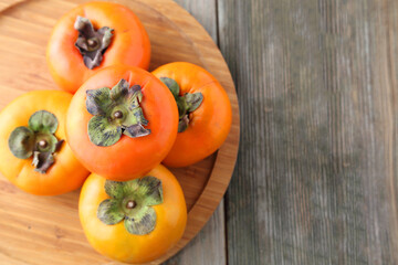 persimmons on wooden table