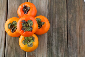 persimmons on wooden table