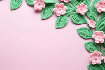 Knitted Pink Flowers and Green Leaves Toy on Pastel with empty space for text