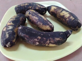 Some rotten bananas on a plate with close up view