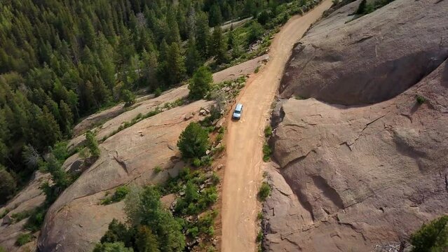 Aerial Panning Shot Of People And Car At Roadside On Mountain Near Trees In Forest - Colorado Springs, Colorado