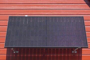 Photovoltaic panels mounted on a house wall in the sun