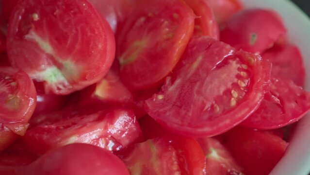Slices of fresh tomatoes close-up in slow motion camera.