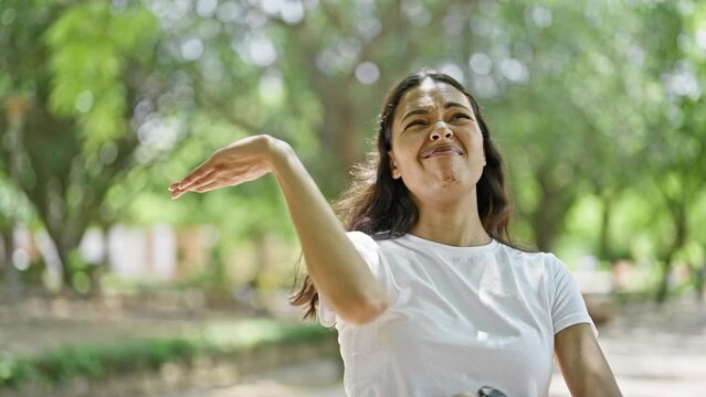 African american woman scratching arm for itchy at park