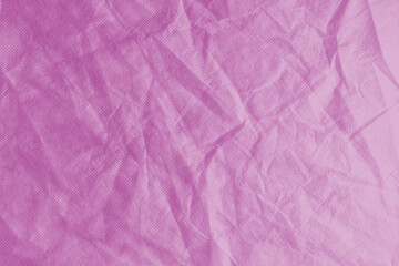 Wrinkled, crumpled pink fabric texture background. Wrinkled and creased abstract backdrop of...