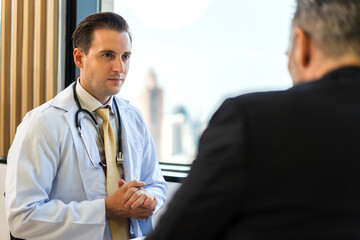 Obraz premium Man doctor wearing uniform with stethoscope service help support discussing and consulting talk to sick senior man patient about checkup result information in hospital.healthcare and medicine