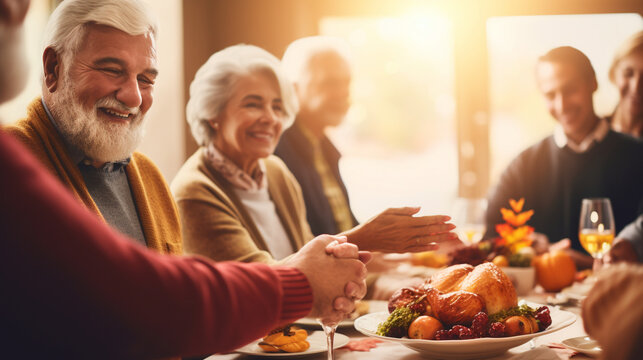 Group of Seniors Holding Hands in Gratitude around a Festively Decorated Table, happy seniors celebrating Thanksgiving, wide banner with copy space area Generative AI